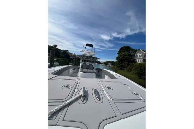 Slide: The Image of 2025 Freeman 42 LR boat docked, showcasing sleek design and spacious deck under a clear sky. - 28