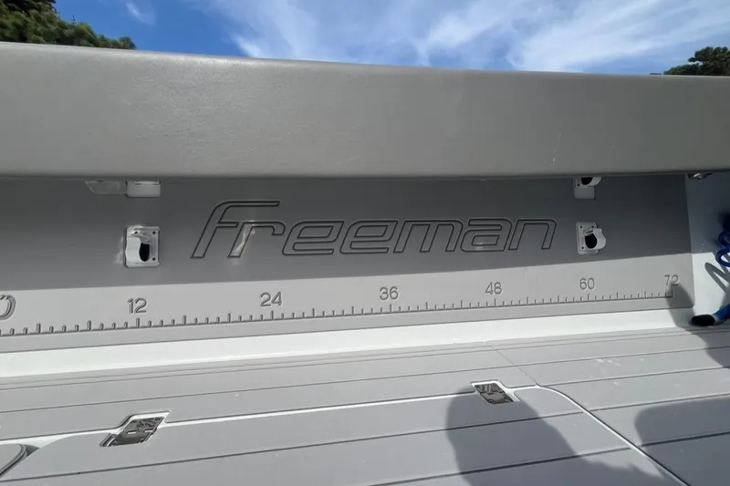 Slide: The Image of Freeman 42 LR boat deck with measurement scale, 2025 model, under clear blue sky. - 37