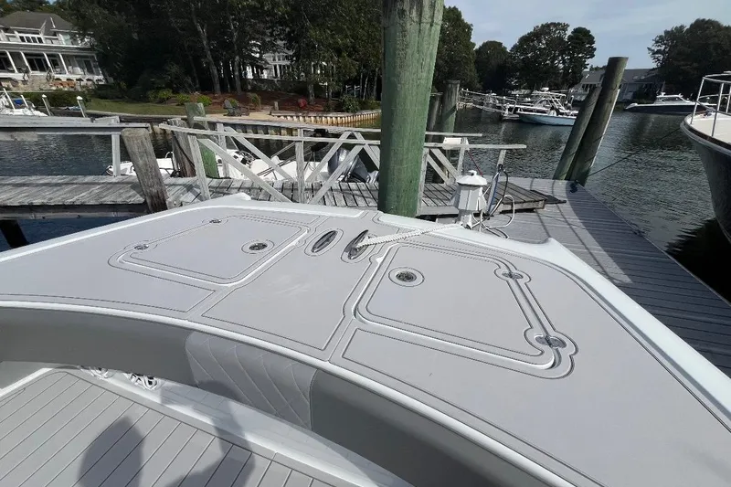 Slide: The Image of 2025 Freeman 42 LR boat docked at a marina with scenic waterfront view. - 38