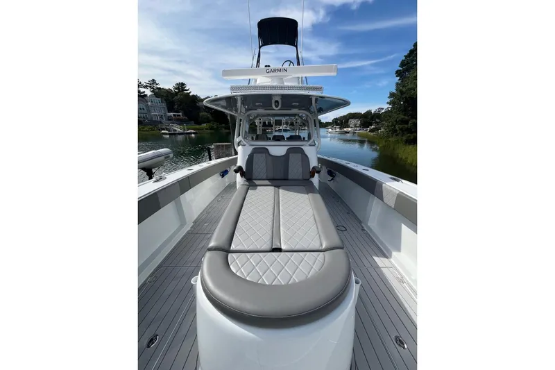 Slide: The Image of 2025 Freeman 42 LR boat with sleek design and luxurious seating on a calm waterway. - 39