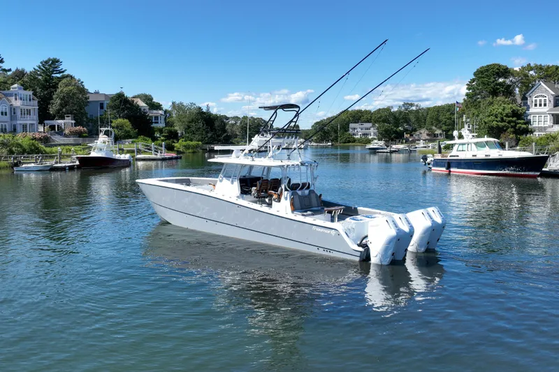 Slide: The Image of 2025 Freeman 42 LR boat with triple engines in a scenic marina setting. - 9