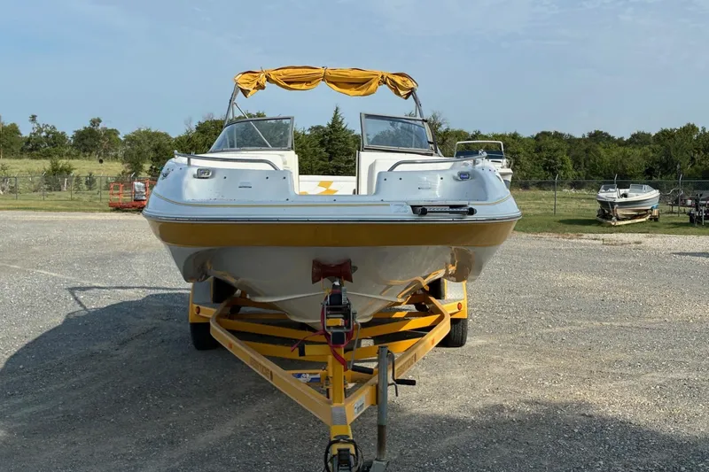 Slide: The Image of 2004 Ebbtide Campione 210 boat on trailer, parked outdoors. - 3