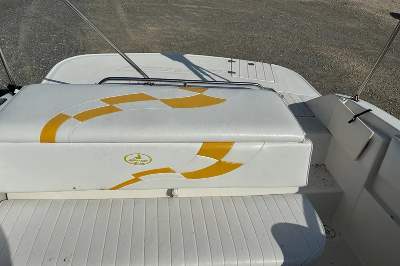 Slide: The Image of 2004 Ebbtide Campione 210 boat interior with yellow design on white seating. - 5