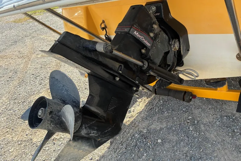 Slide: The Image of 2004 Ebbtide Campione 210 boat with MerCruiser outdrive on gravel surface. - 6