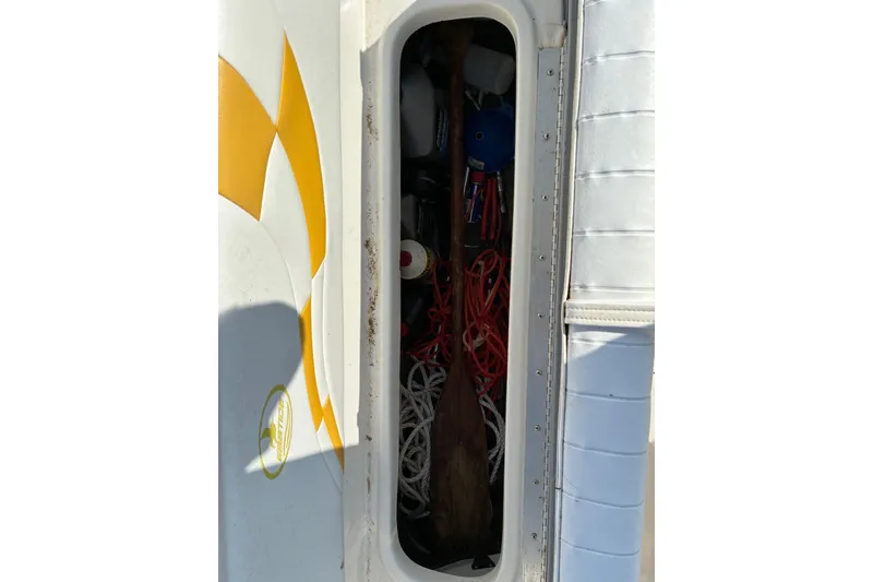 Slide: The Image of Storage compartment of 2004 Ebbtide Campione 210 boat with ropes and equipment. - 7