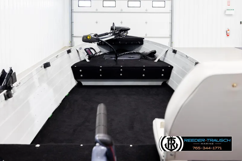 Slide: The Image of 1993 Sylvan 14 VFO boat interior with black carpet and mounted equipment. - 12