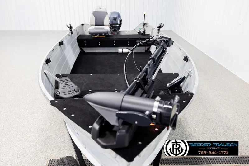 Slide: The Image of 1993 Sylvan 14 VFO boat interior with motor and fishing equipment. - 15