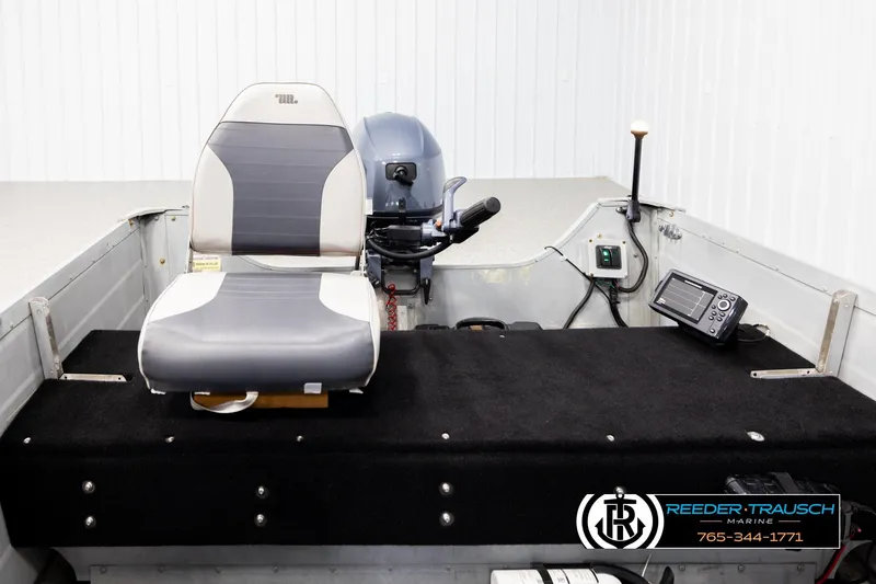 Slide: The Image of Interior of a 1993 Sylvan 14 VFO boat with seating and control panel. - 17