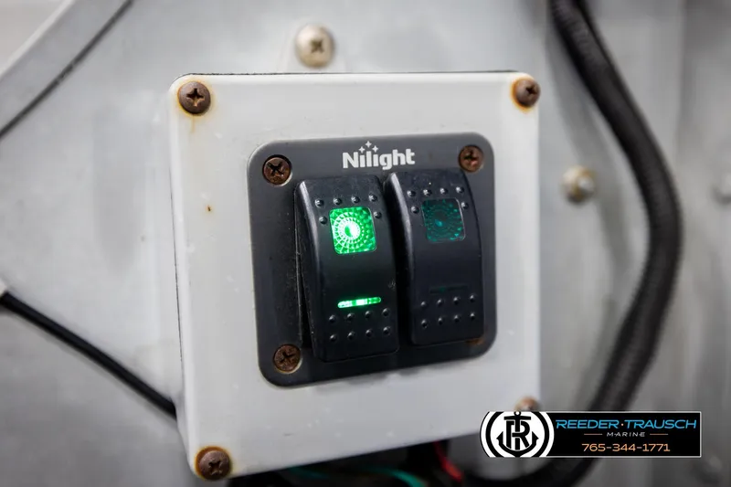 Slide: The Image of Switch panel with illuminated buttons on a 1993 Sylvan 14 VFO boat. - 22