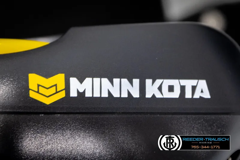 Slide: The Image of Minn Kota logo on a black surface, featuring Reeder-Trausch Marine branding. - 28