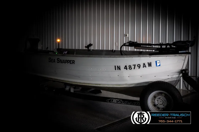 Slide: The Image of 1993 Sylvan 14 VFO boat "Sea Snapper" on trailer, displayed indoors at Reeder-Trausch Marine. - 3