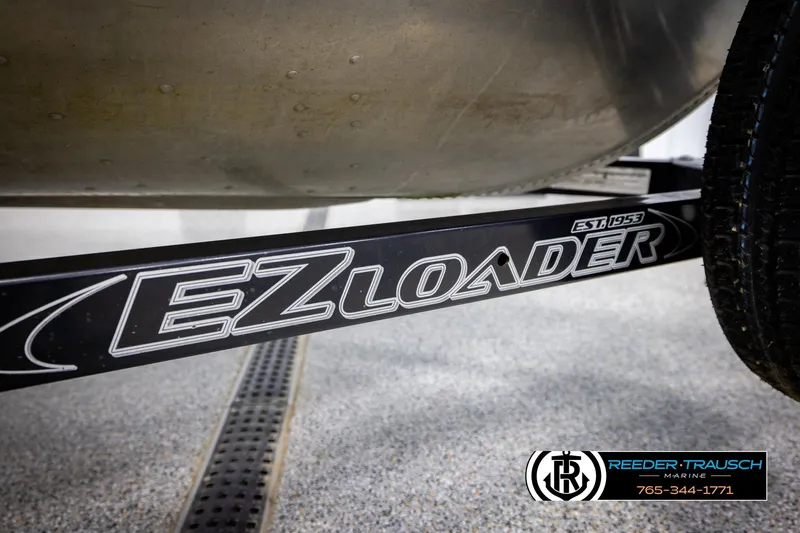 Slide: The Image of EZ Loader trailer with Sylvan 14 VFO boat, Reeder-Trausch Marine branding visible. - 34