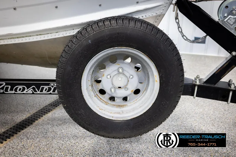Slide: The Image of Trailer wheel of a 1993 Sylvan 14 VFO boat, displayed at Reeder-Trausch Marine. - 35