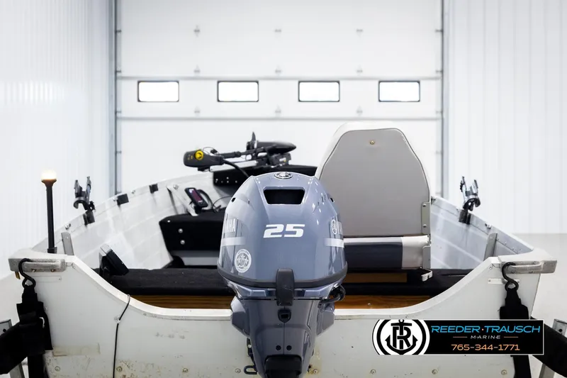 Slide: The Image of 1993 Sylvan 14 VFO boat with Yamaha 25 outboard motor in a garage setting. - 6