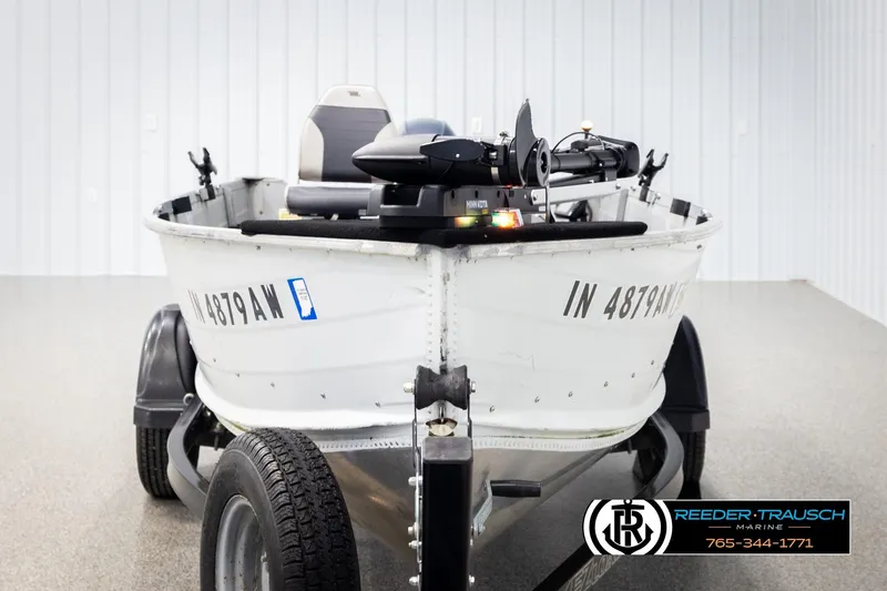 Slide: The Image of 1993 Sylvan 14 VFO boat on trailer, displayed indoors at Reeder-Trausch Marine. - 7