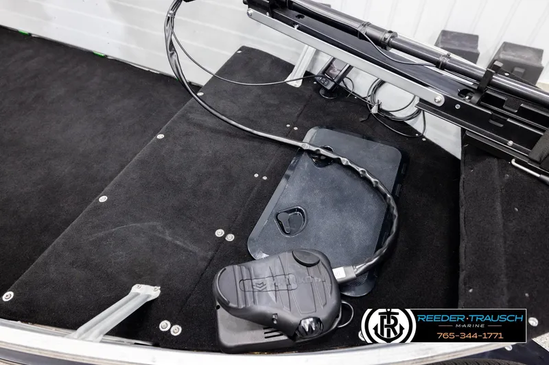 Slide: The Image of Interior of a 1993 Sylvan 14 VFO boat with black carpet and control panel. - 8