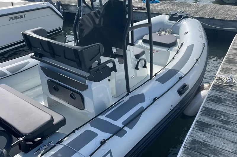 Slide: The Image of 2025 Zodiac Pro 5.5 boat docked, featuring sleek seating and modern design. - 10