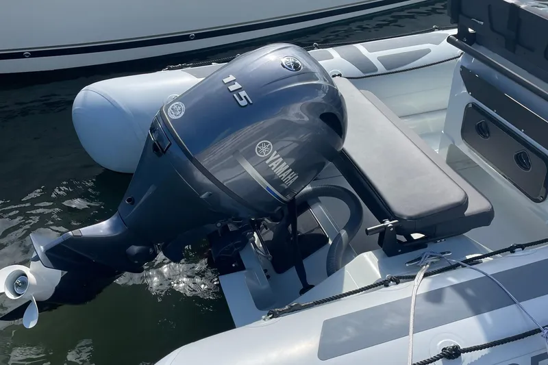 Slide: The Image of 2025 Zodiac Pro 5.5 boat with Yamaha 115 outboard motor on water. - 12