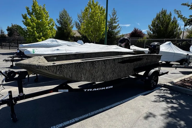 The Image of 2026 Tracker Grizzly 1650 T Prairie Wings Edition boat on trailer in parking lot. - 0