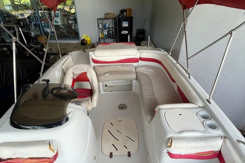 Slide: The Image of 2007 Tahoe 195s boat interior with red and white seating, steering wheel, and canopy. - 10