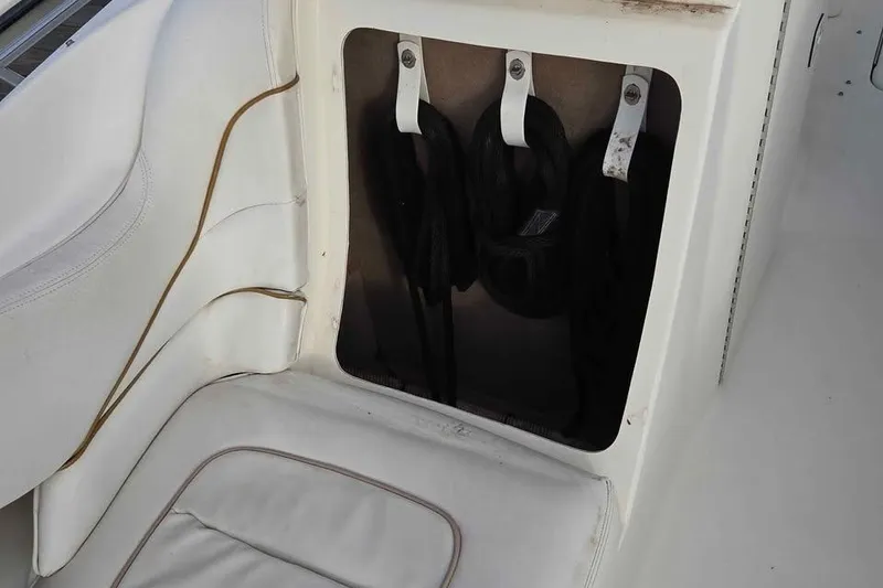 Slide: The Image of Storage compartment on a 1999 Sea Ray 280 Bow Rider boat with coiled ropes. - 6