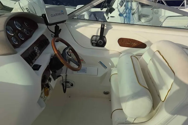 Slide: The Image of 1999 Sea Ray 280 Bow Rider cockpit with Garmin GPS and white leather seating. - 7