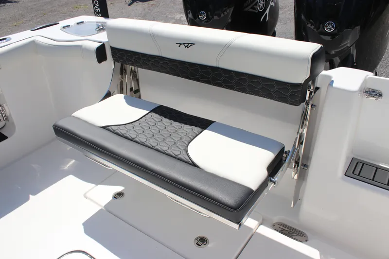 Slide: The Image of 2026 Tidewater 256 CC Adventure boat seat with black and white upholstery. - 10