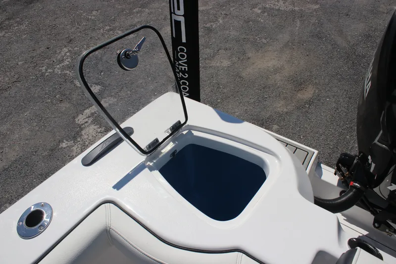 Slide: The Image of 2026 Tidewater 256 CC Adventure boat with open storage compartment. - 12