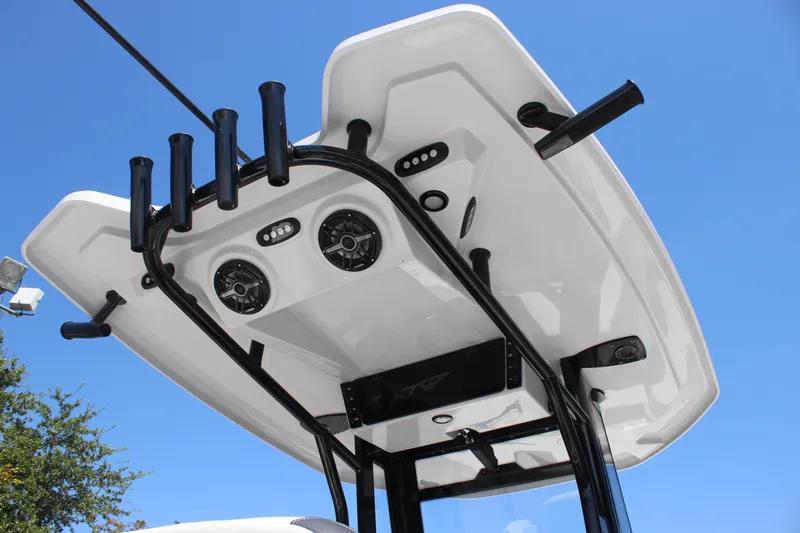 Slide: The Image of Tidewater 256 CC Adventure 2026 boat top view with rod holders and speakers against blue sky. - 16