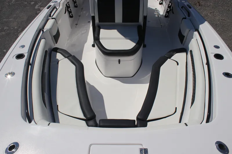 Slide: The Image of 2026 Tidewater 256 CC Adventure boat interior with cushioned seating and sleek design. - 18