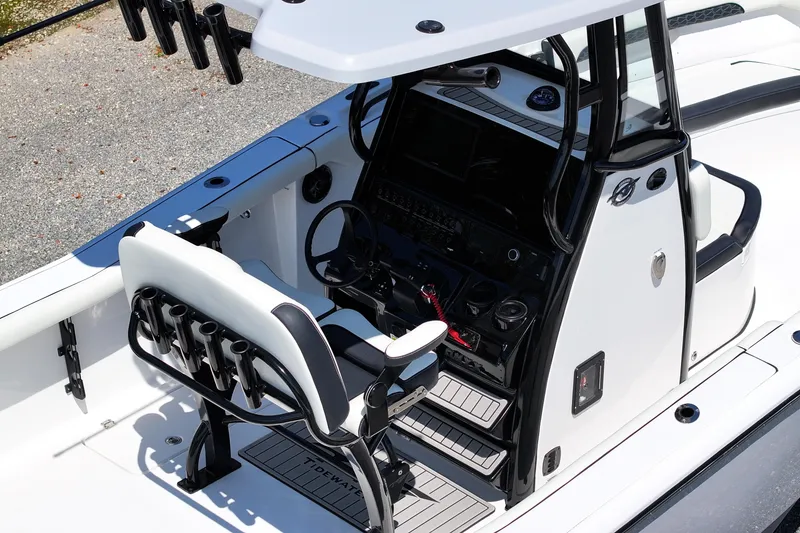 Slide: The Image of 2026 Tidewater 256 CC Adventure boat cockpit with modern controls and seating. - 24