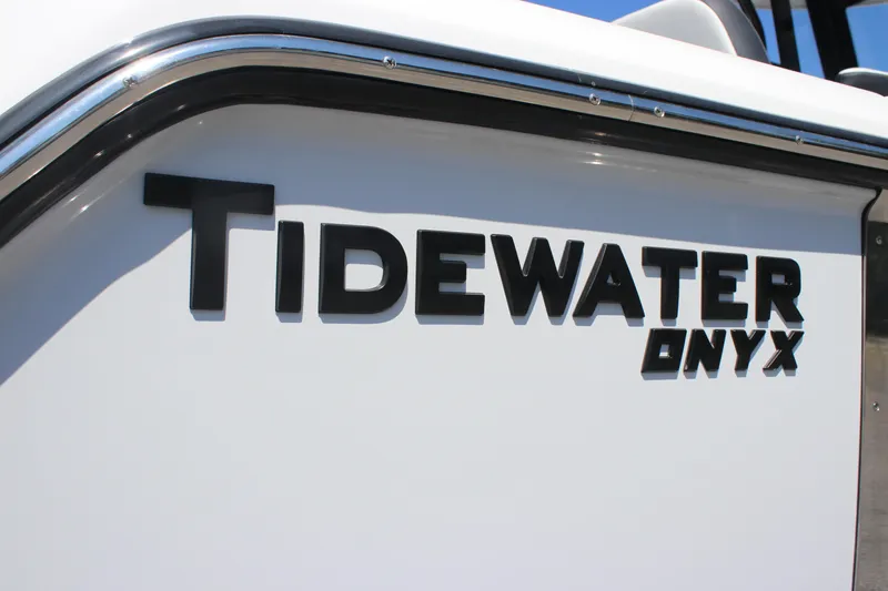 Slide: The Image of 2026 Tidewater 256 CC Adventure boat with Onyx branding on white hull. - 4