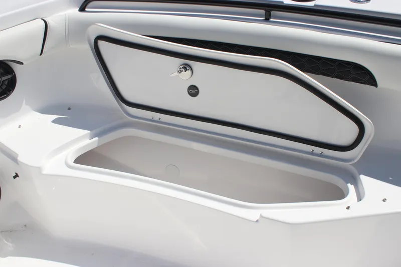 Slide: The Image of 2026 Tidewater 256 CC Adventure boat storage compartment with open hatch. - 8