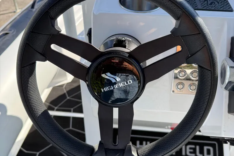 Slide: The Image of Steering wheel of 2024 Highfield Sport 560 boat, featuring sleek design and controls. - 20