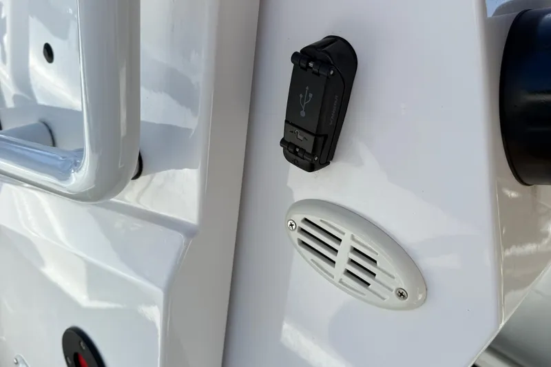 Slide: The Image of 2024 Highfield Sport 560 boat detail with USB port and speaker grille. - 22
