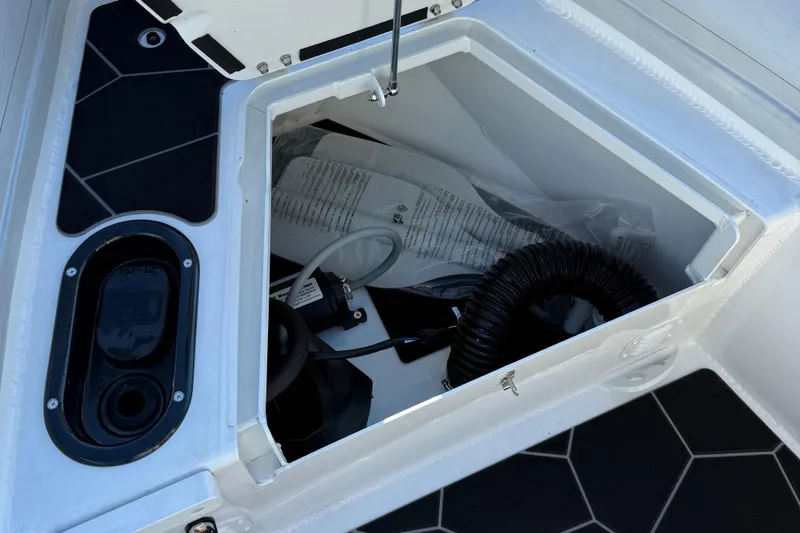 Slide: The Image of Open storage compartment on 2024 Highfield Sport 560 boat, showing interior equipment and accessories. - 25