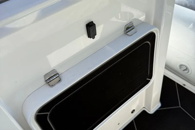 Slide: The Image of 2024 Highfield Sport 560 boat storage compartment with secure latch and sleek design. - 30