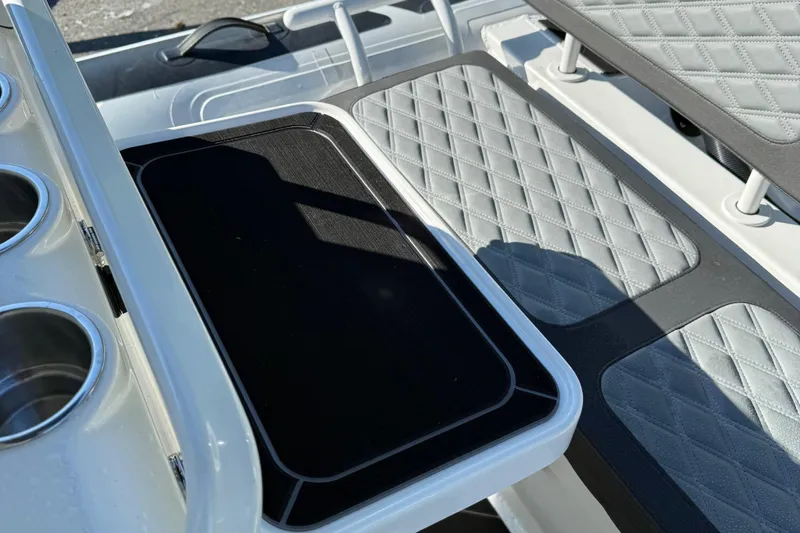 Slide: The Image of 2024 Highfield Sport 560 boat interior with quilted seating and cup holders. - 31