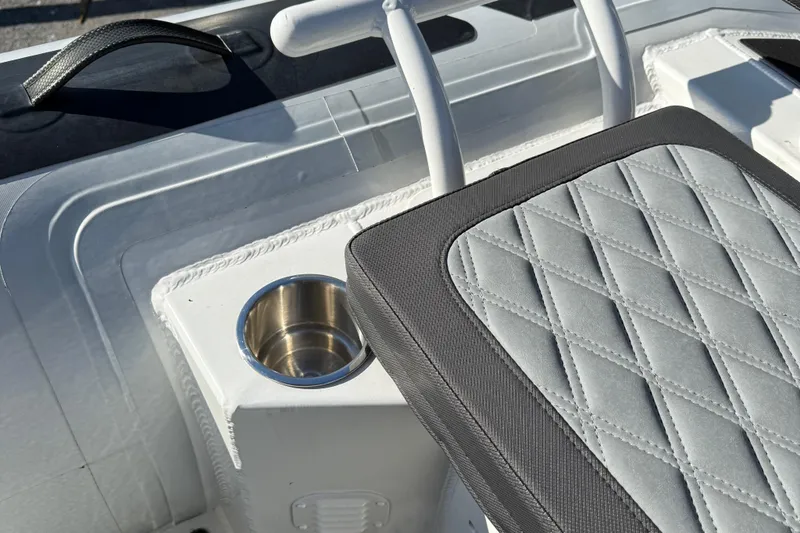 Slide: The Image of 2024 Highfield Sport 560 boat seat with diamond-stitched upholstery and integrated cup holder. - 32
