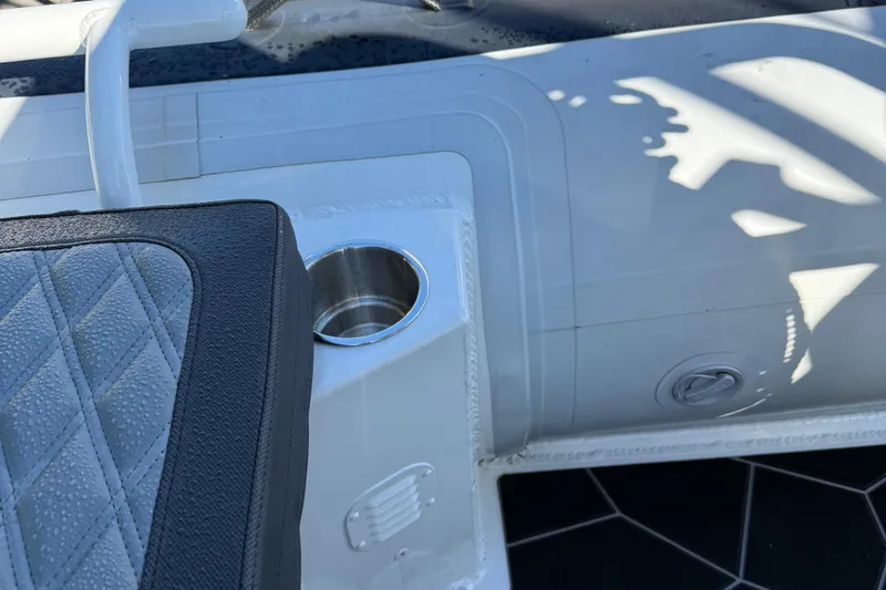 Slide: The Image of 2024 Highfield Sport 560 boat interior with cup holder and cushioned seat detail. - 33
