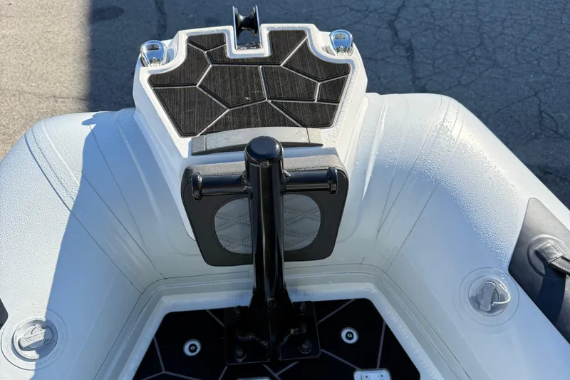 Slide: The Image of 2024 Highfield Sport 560 boat bow with textured deck and sleek design. - 34