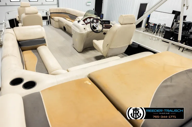Slide: The Image of Interior of 2011 Misty Harbor 2285 CS pontoon boat with beige seating and steering console. - 11
