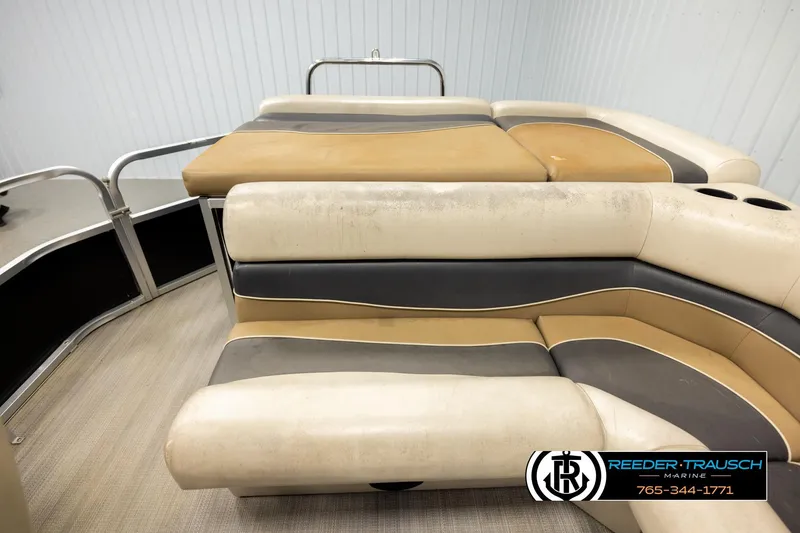 Slide: The Image of 2011 Misty Harbor 2285 CS pontoon boat interior with beige and gray seating. - 15