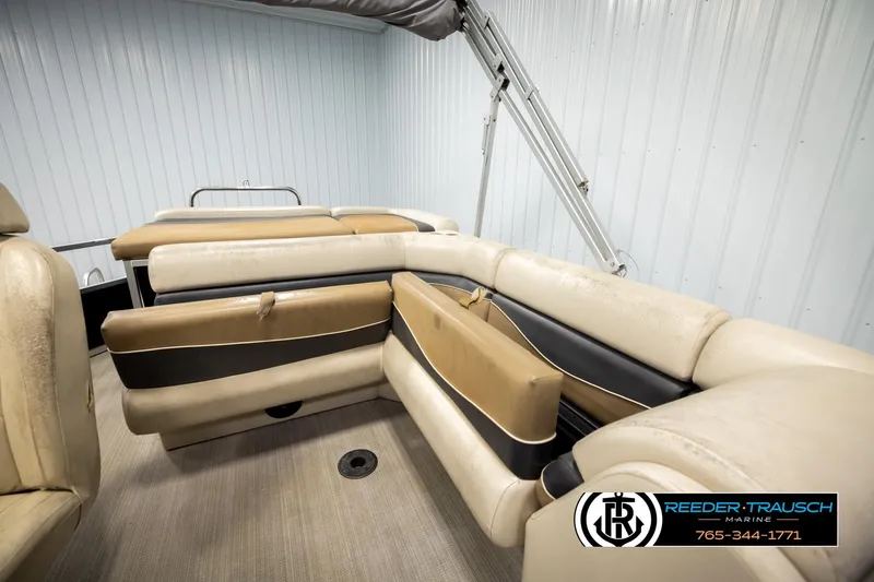 Slide: The Image of 2011 Misty Harbor 2285 CS pontoon boat interior with beige and black seating. - 22