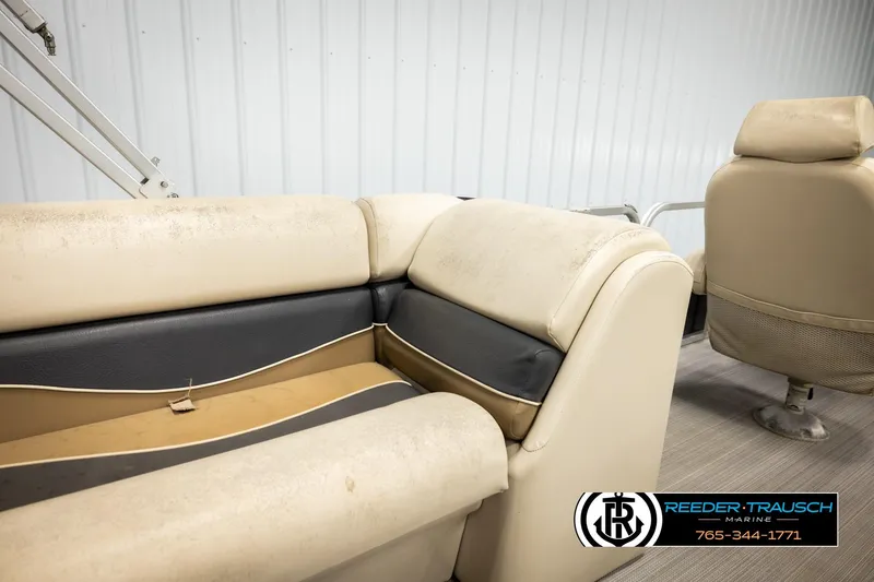 Slide: The Image of 2011 Misty Harbor 2285 CS boat interior with beige and black seating. - 23