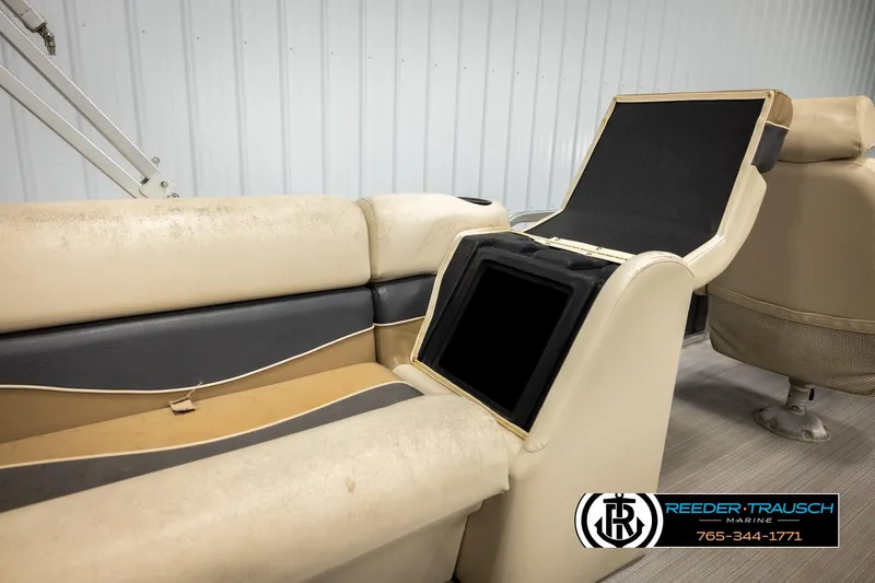 Slide: The Image of 2011 Misty Harbor 2285 CS boat interior with beige seating and storage compartment. - 24