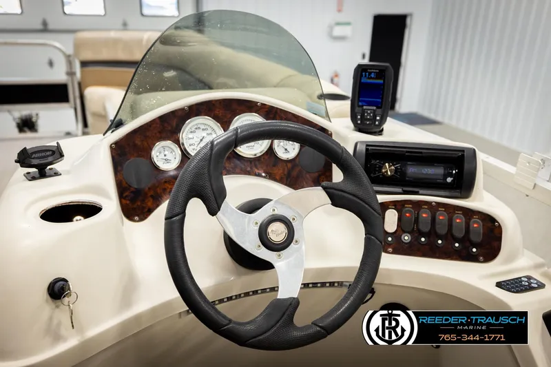 Slide: The Image of Steering console of 2011 Misty Harbor 2285 CS pontoon boat with gauges and controls. - 26