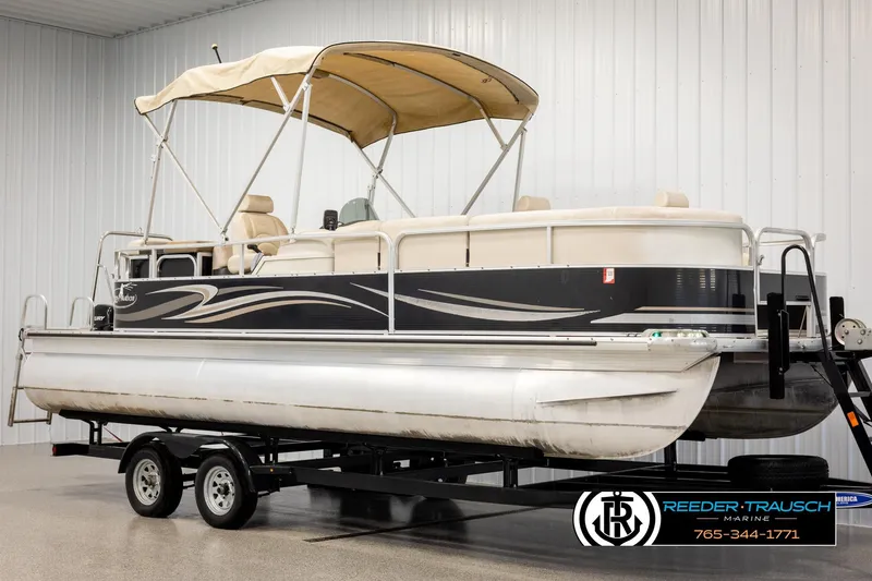 Slide: The Image of 2011 Misty Harbor 2285 CS pontoon boat on trailer, indoor setting, beige canopy. - 3