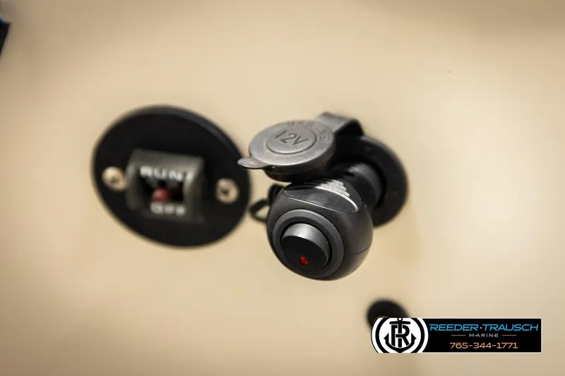 Slide: The Image of 12V socket and switch on 2011 Misty Harbor 2285 CS boat dashboard. - 32