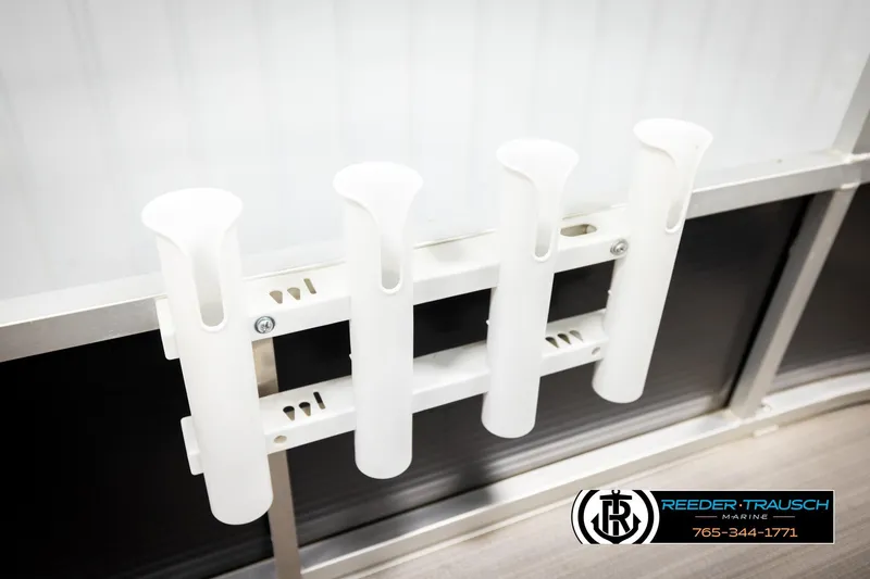 Slide: The Image of White rod holders on a 2011 Misty Harbor 2285 CS boat, Reeder-Trausch Marine logo visible. - 39